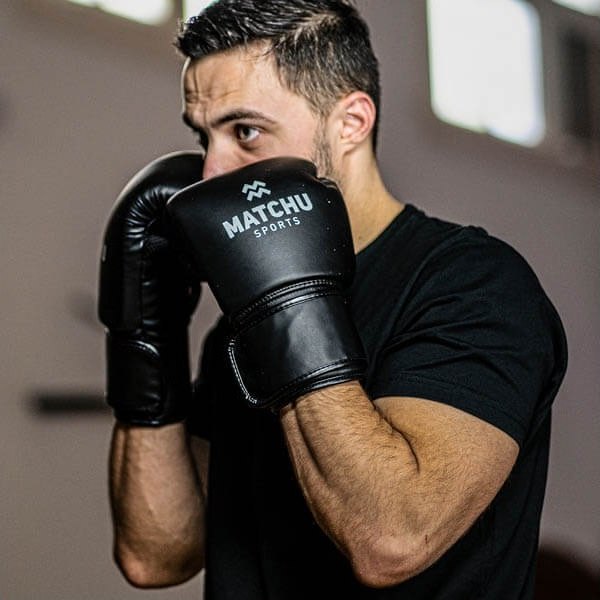 A boxer in MATCHU gloves, guard up