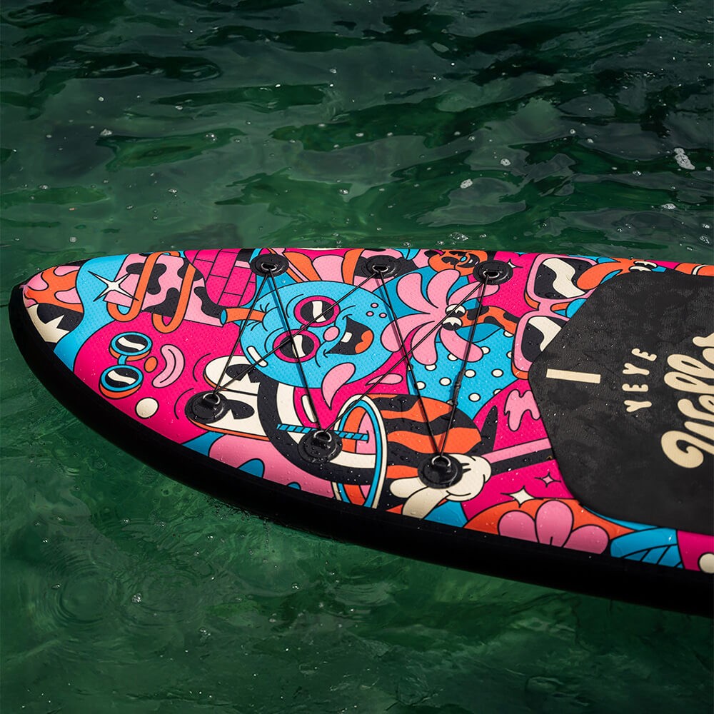 YeYe Weller artwork on the nose of the SUP board, on green water